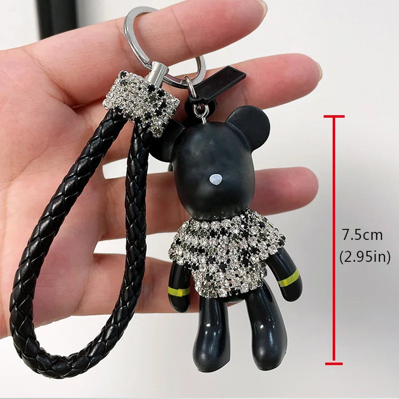 Cute rhinestone bear keychain with black braided strap held in hand showing size 7.5 cm