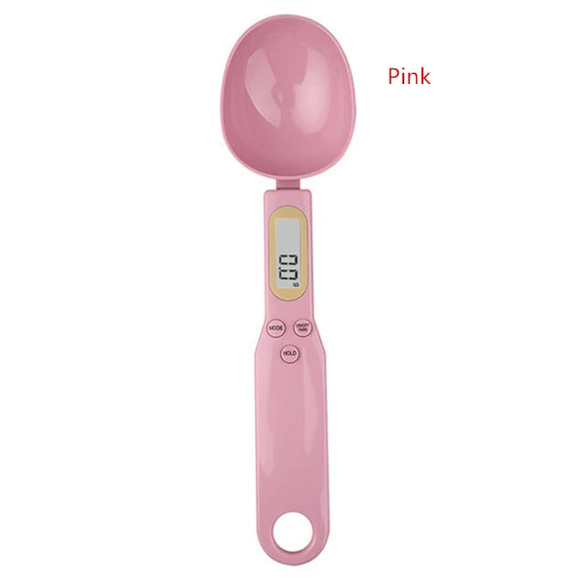 Pink digital measuring spoon scale with LCD display and control buttons for precise ingredient measurement