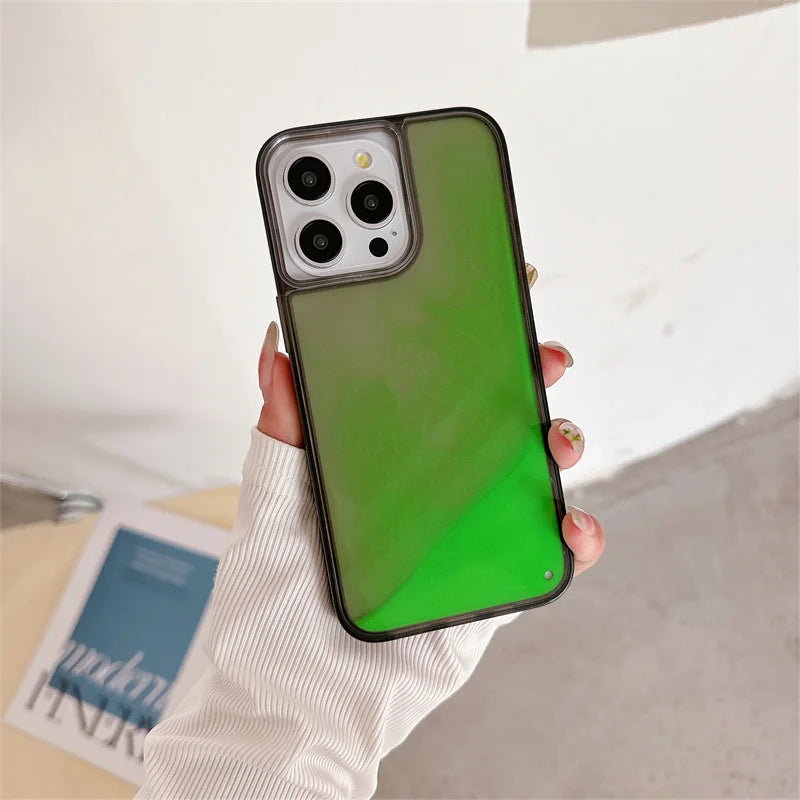 Luminous sand iPhone case glowing green held in hand with white sleeve on background