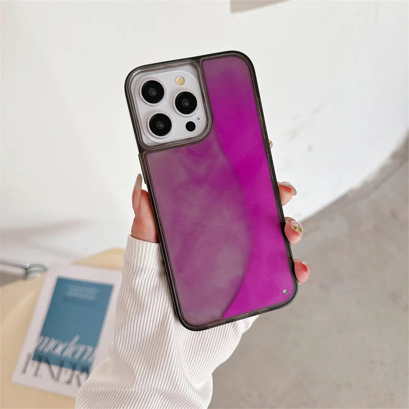 Hand holding purple luminous sand iPhone case with black edges on white background
