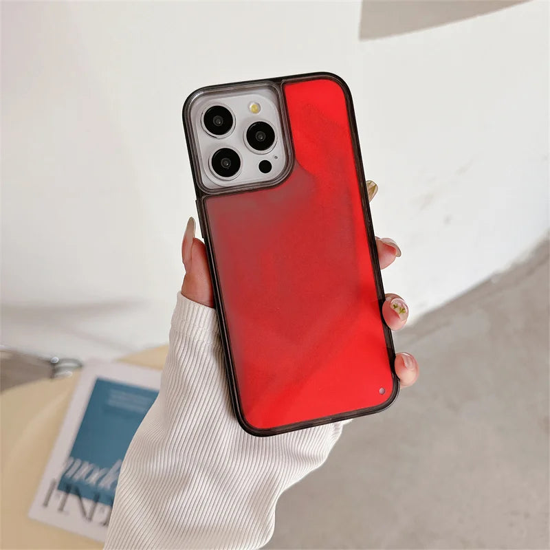 Luminous sand iPhone case in red held in hand with triple camera cutout and black edges