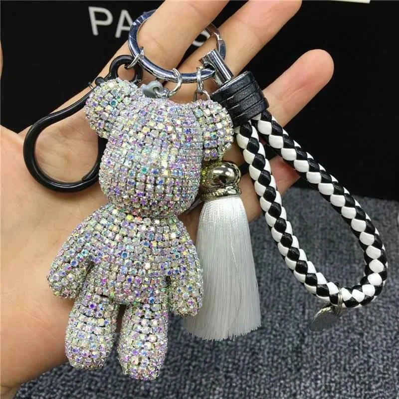 Shiny rhinestone bear keychain with braided black and white strap and white tassel accessory