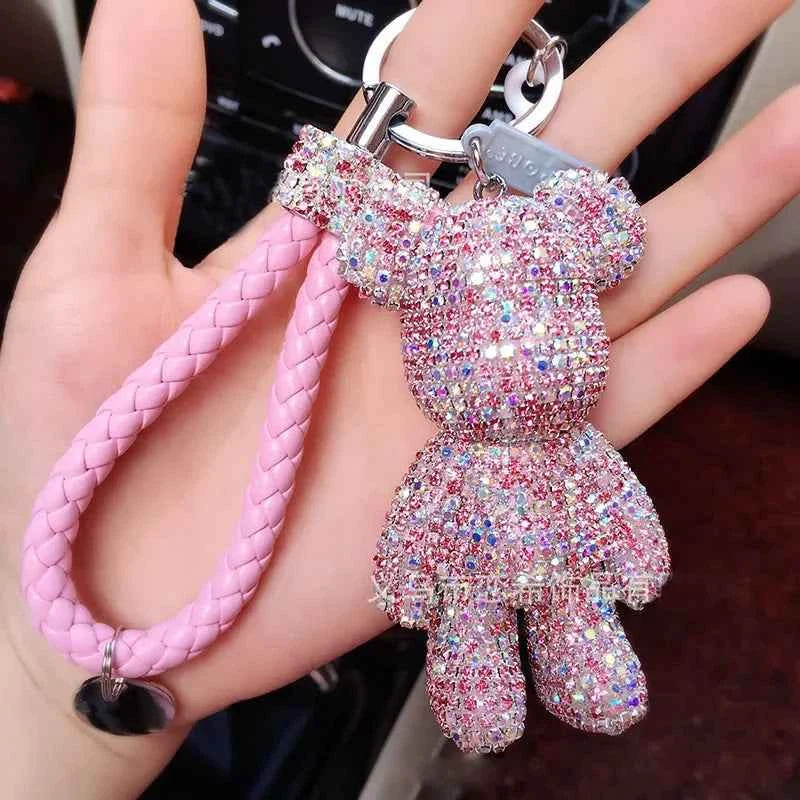 DFShop rhinestone bear keychain in sparkling pink with braided strap held in hand