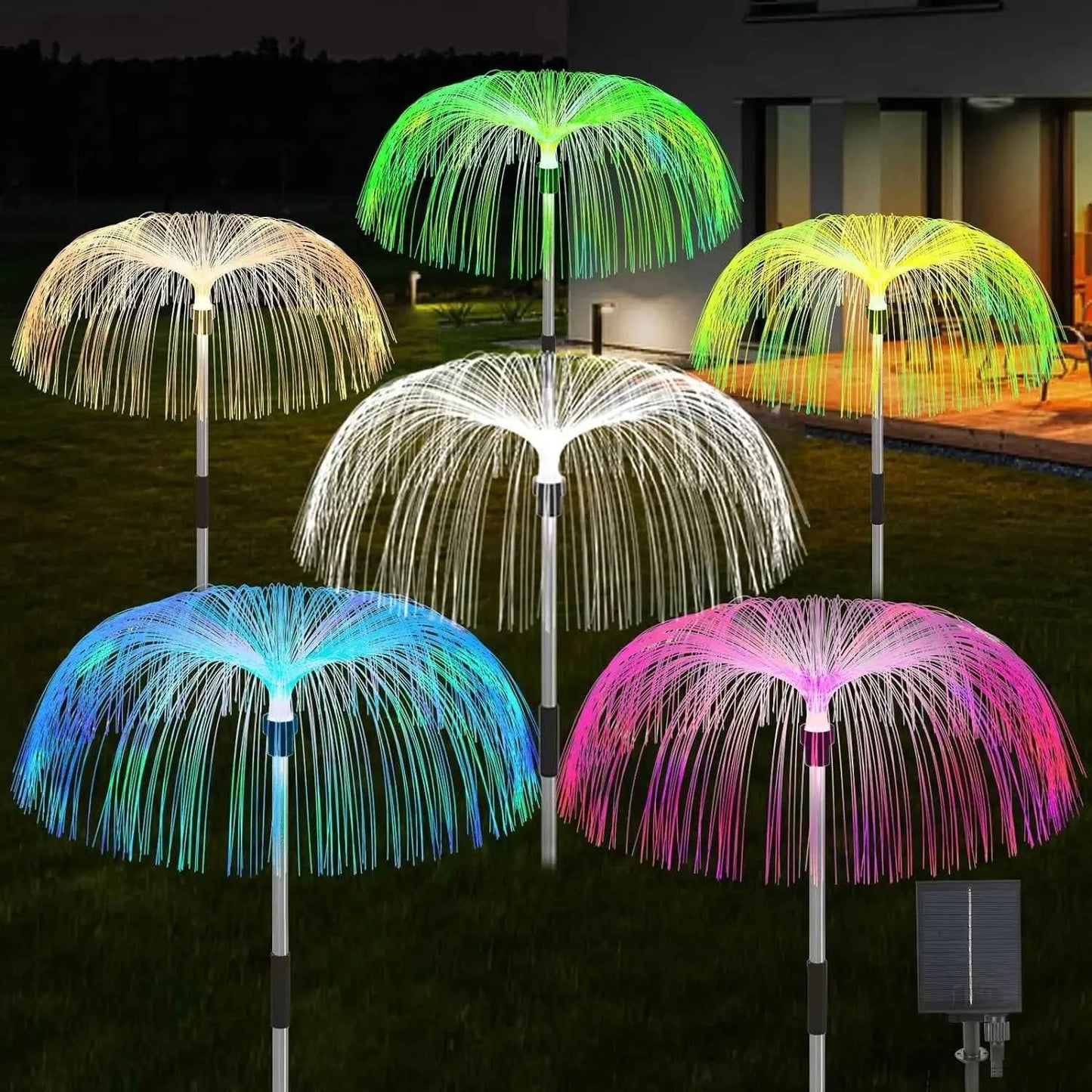 Colorful solar jellyfish garden lights glowing in various colors on a lawn at night