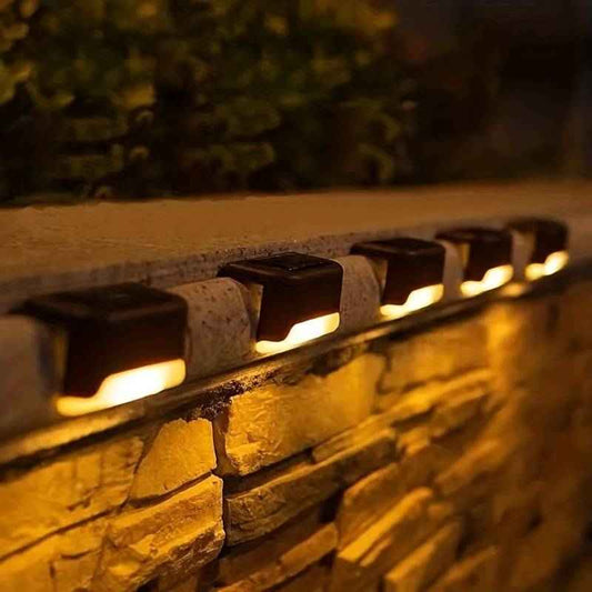 DFShop cordless solar wall lights illuminating stone outdoor wall with warm light at night