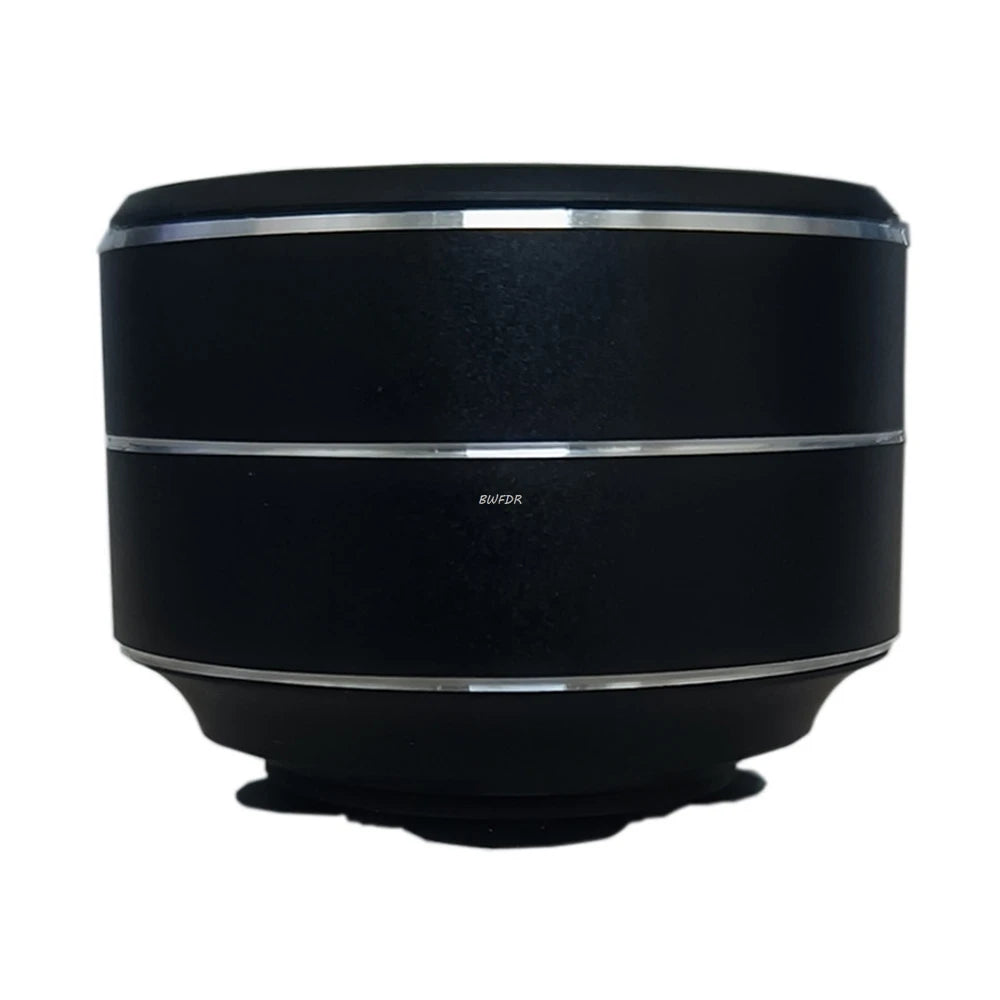 Black wireless mini vibration speaker with silver trim rings and compact round design