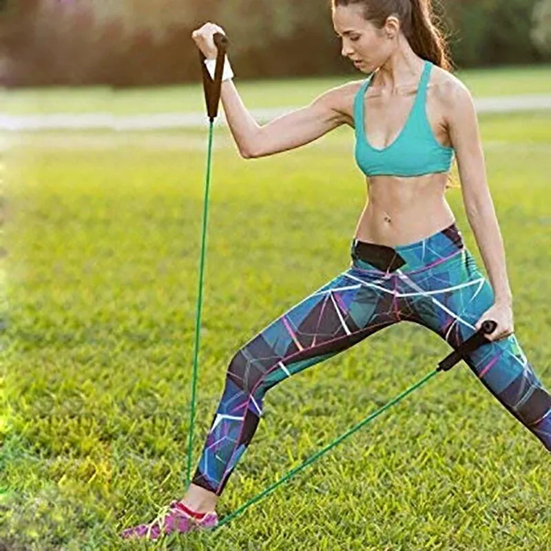 Woman exercising outdoors with the best resistance bands for home exercise in green color