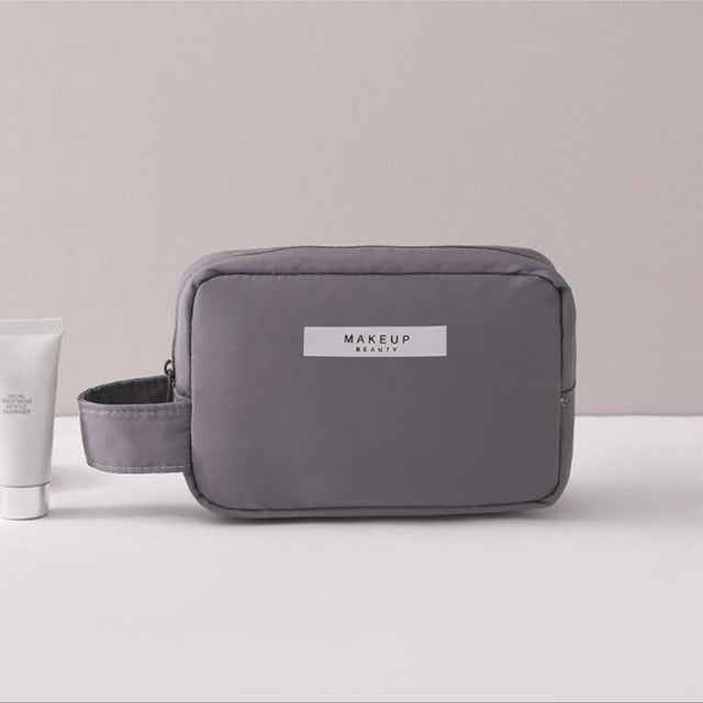 Gray portable cosmetic organizer by DFShop with handle and front label for makeup storage
