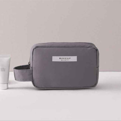 Gray portable cosmetic organizer by DFShop with handle and front label for makeup storage