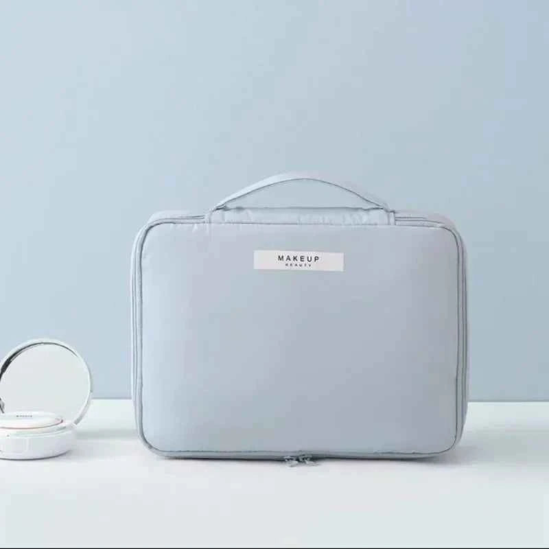 Light gray portable cosmetic organizer with handle and zip closure by DFShop on light background
