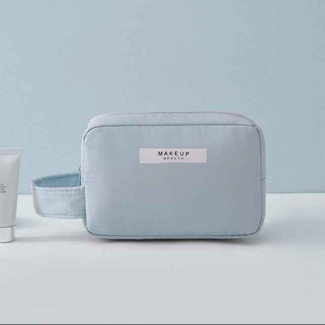 Light blue portable cosmetic organizer bag with side handle and zipper closure