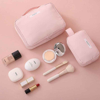 Pink portable cosmetic organizer set with two bags, makeup brushes, foundation, lipstick, and compact powder