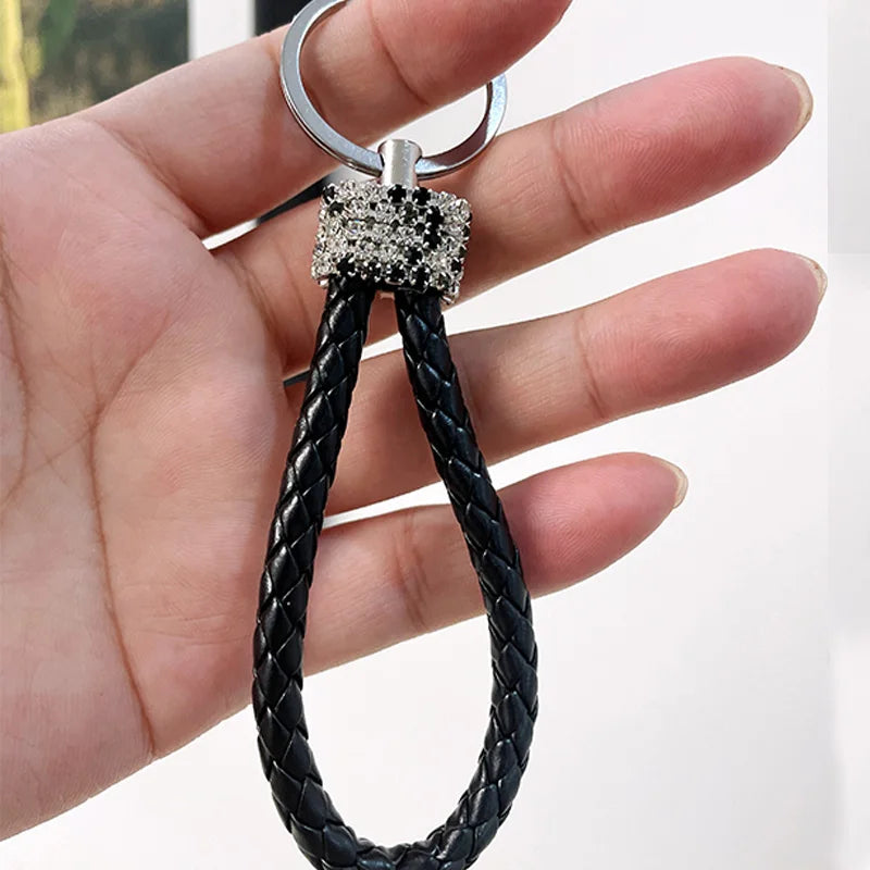 Cute rhinestone bear keychain with braided black leather loop held in hand by DFShop