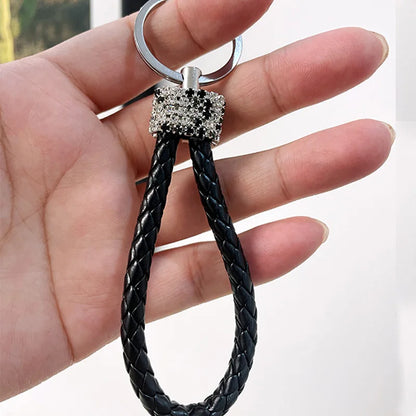 Cute rhinestone bear keychain with braided black leather loop held in hand by DFShop