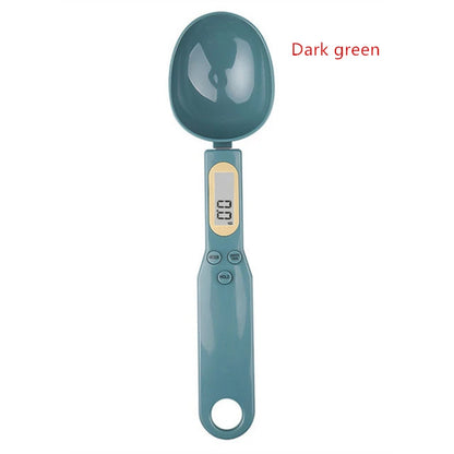 Dark green digital measuring spoon scale with LCD display and control buttons for precise ingredient measurement