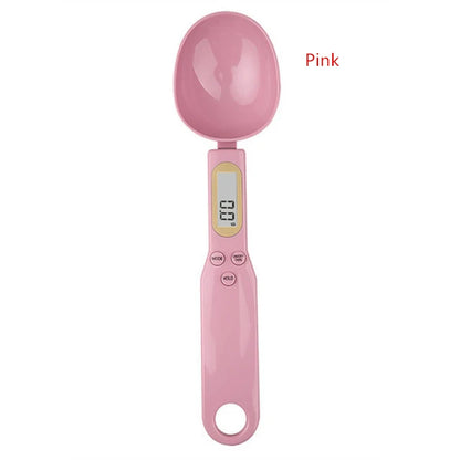 Pink digital measuring spoon scale with LCD display and control buttons for precise ingredient measurement