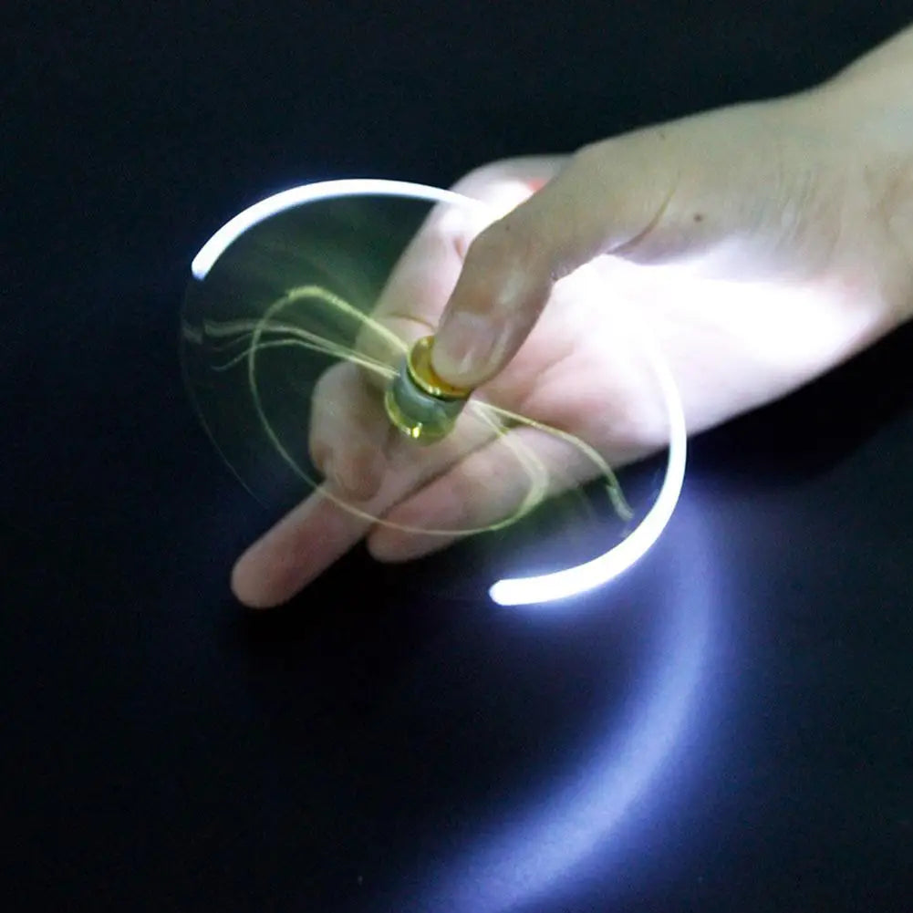 Hand spinning a glowing fidget spinner pen with light trails on black background