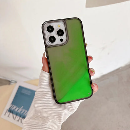 Luminous sand iPhone case glowing green held in hand with white sleeve on background