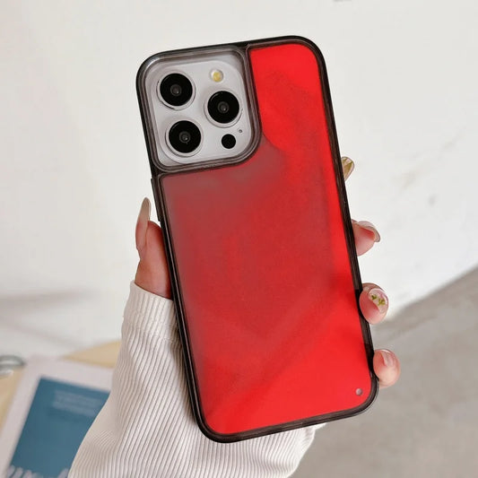 Hand holding red luminous sand iPhone case with black edges and triple camera cutout
