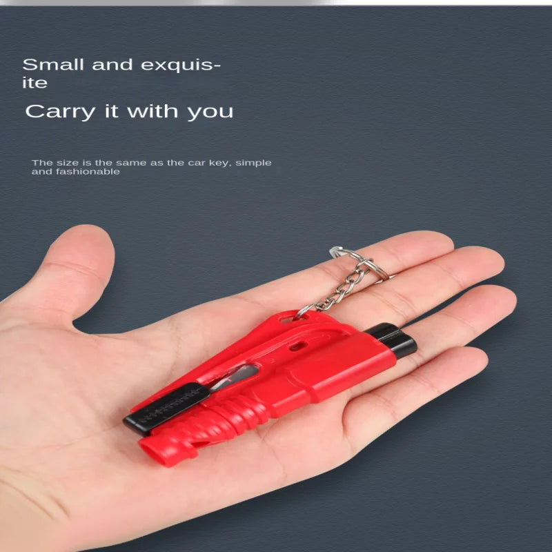 Red keychain safety hammer held in hand designed to be small, stylish, and easy to carry