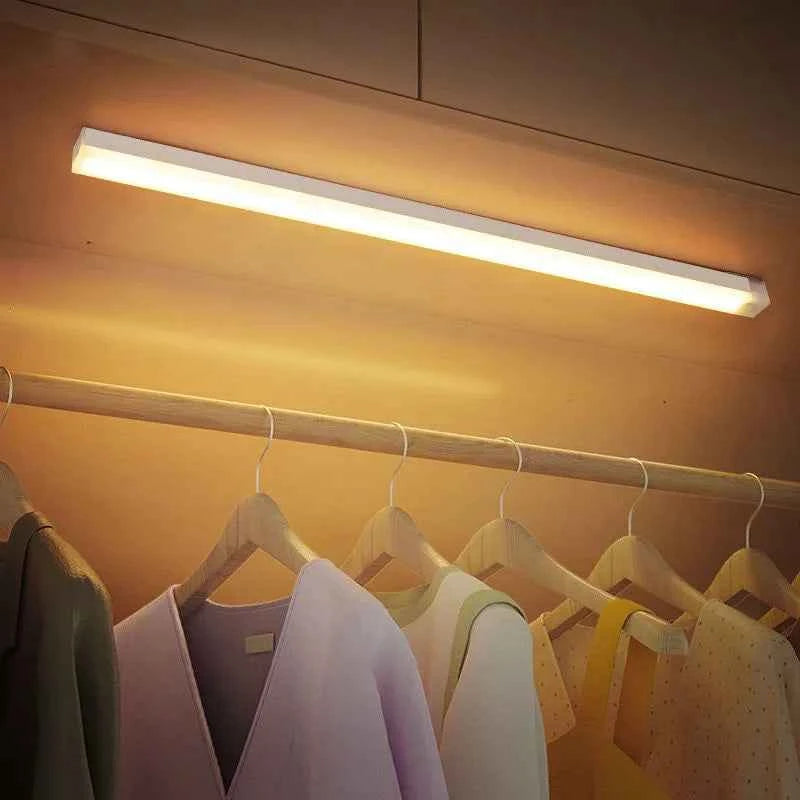 DFShop LED motion sensor light mounted above clothing rack illuminating hanging clothes