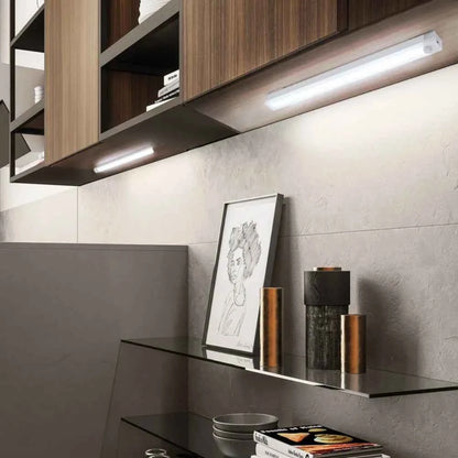 DFShop LED motion sensor light installed under wooden kitchen cabinets illuminating countertop