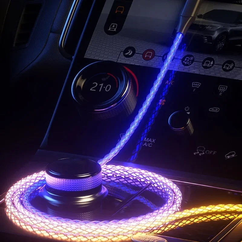 RGB USB C fast charging cable illuminated in purple and yellow inside a car dashboard charging port