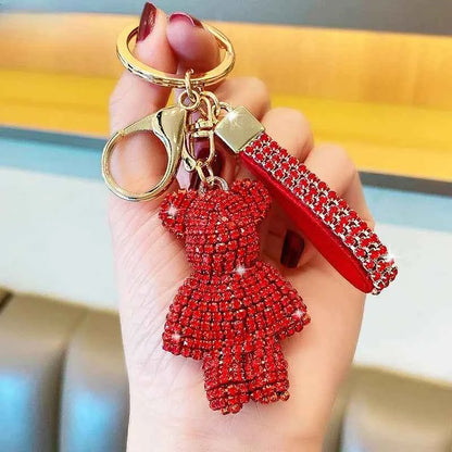 Red rhinestone bear keychain with gold keyring and clasp held in hand by DFShop
