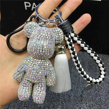 Shiny rhinestone bear keychain with braided black and white strap and white tassel accessory