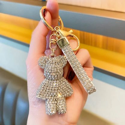 Rhinestone bear keychain with sparkling crystals and gold-tone hardware held in hand