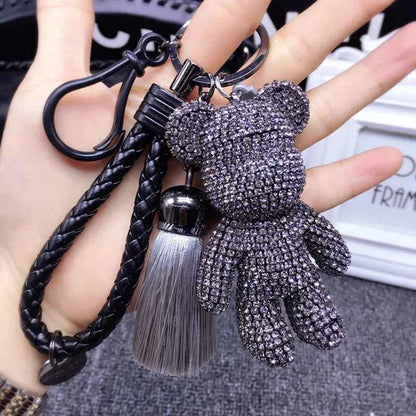 Shiny rhinestone bear keychain with black braided strap and gray tassel accessory