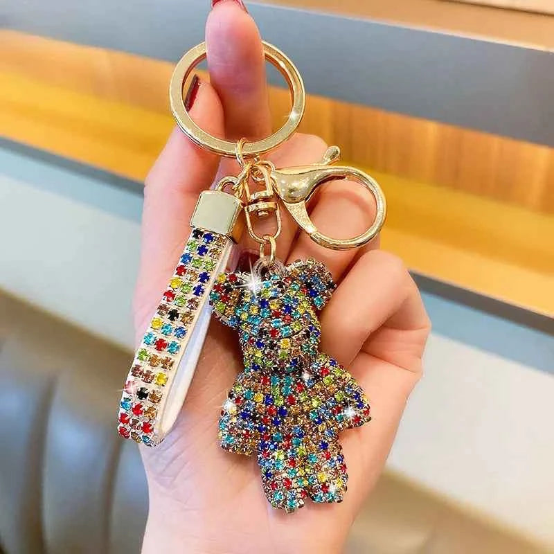 Colorful rhinestone bear keychain attached to gold keyring with matching rhinestone strap