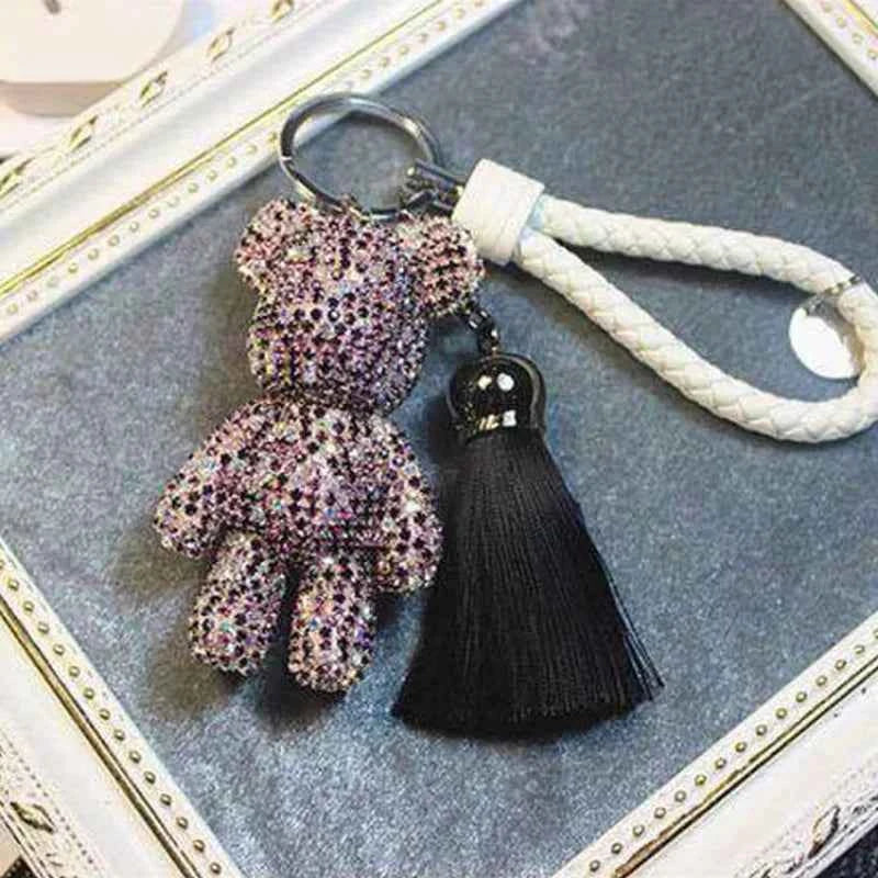 DFShop rhinestone bear keychain with sparkling stones attached to a white braided strap and black tassel