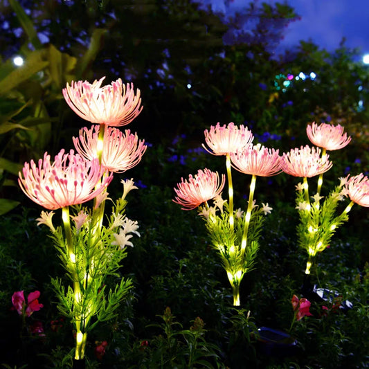 DFShop solar flower garden lights glowing pink and white in a nighttime garden setting