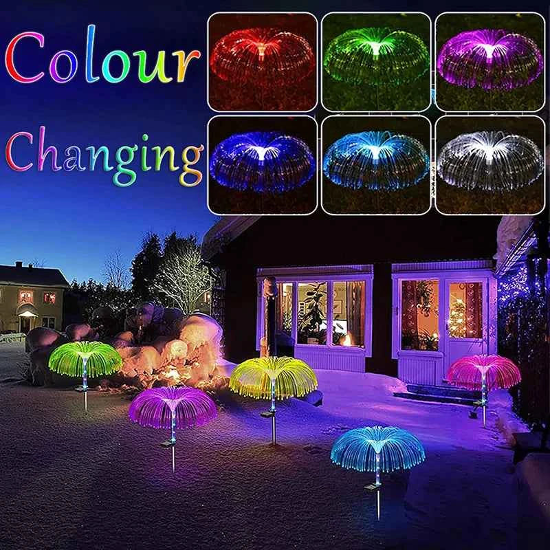 Colour changing solar jellyfish garden lights glowing in multiple colors in a nighttime garden