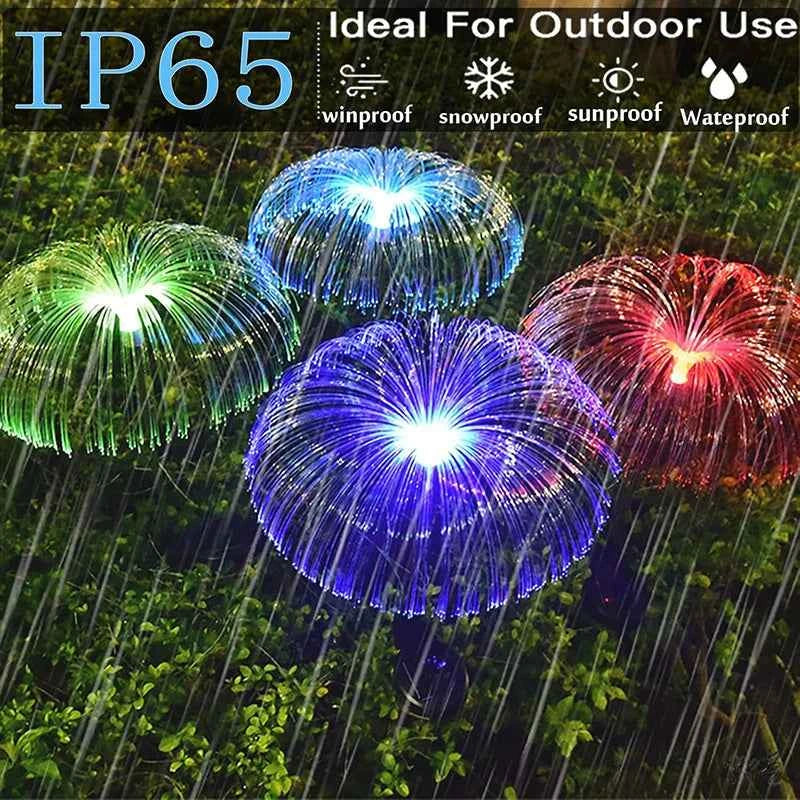 Colorful solar jellyfish garden lights glowing in rain with IP65 waterproof rating for outdoor use