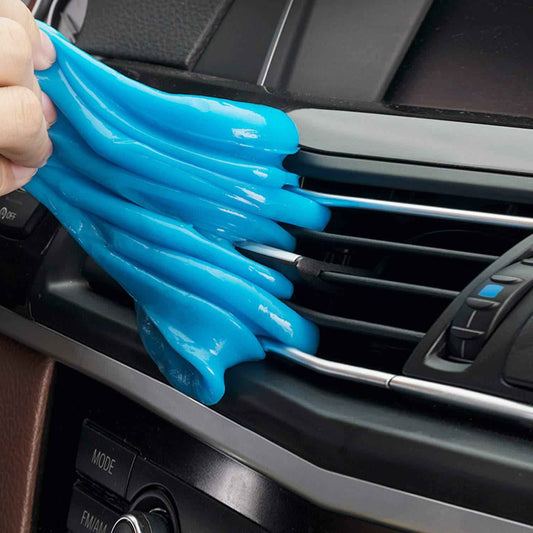 Blue car cleaning gel removing dust and dirt from car air vent and dashboard