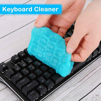 Hands using blue car cleaning gel keyboard cleaner to remove dust from black mechanical keyboard keys