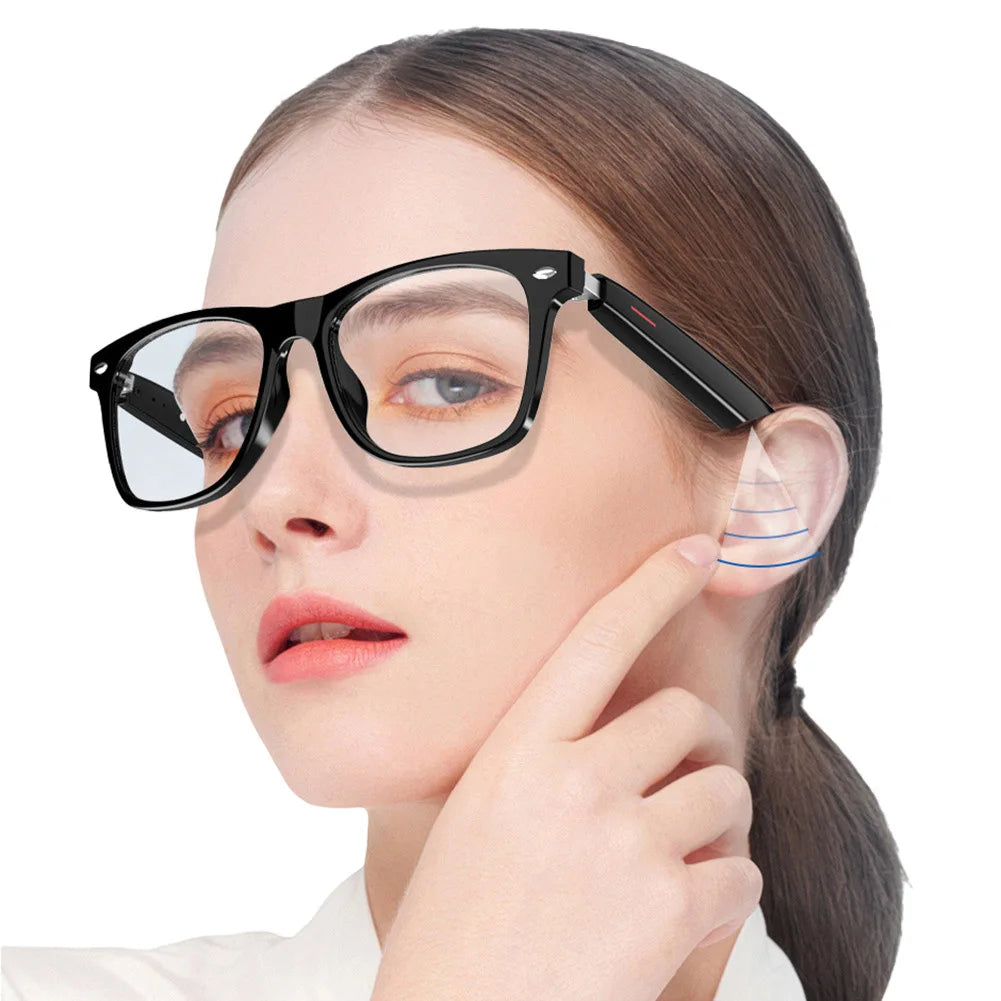 Woman wearing black AI smart glasses with speakers touching ear to demonstrate audio feature