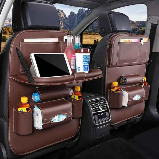 Leather car back seat organizer with multiple pockets holding bottles, tissues, and a tablet in a car interior