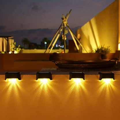 Cordless solar wall lights mounted on an outdoor wall illuminating a patio at dusk