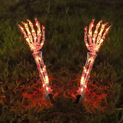 Halloween ghost hand lights glowing orange skeleton hands lighting up grass at night