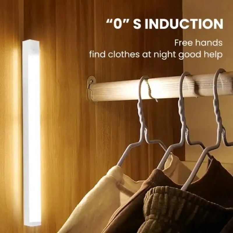 Wireless LED motion sensor night light illuminating a wooden closet to easily find clothes at night