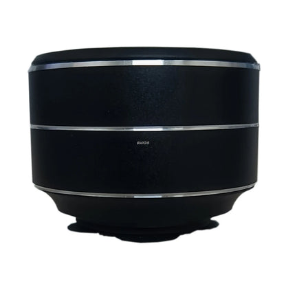 Black wireless mini vibration speaker with silver trim rings and compact round design